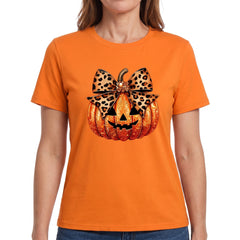 Woman wearing the orange pumpkin graphic henley top