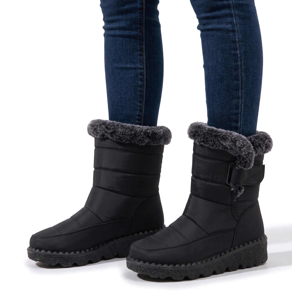 Women's cosy quilted winter boots with grey faux fur cuff worn with jeans