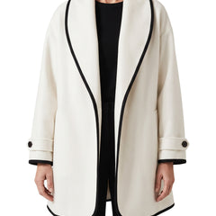 Women's oversized white wool trench coat with wide lapels and black trim