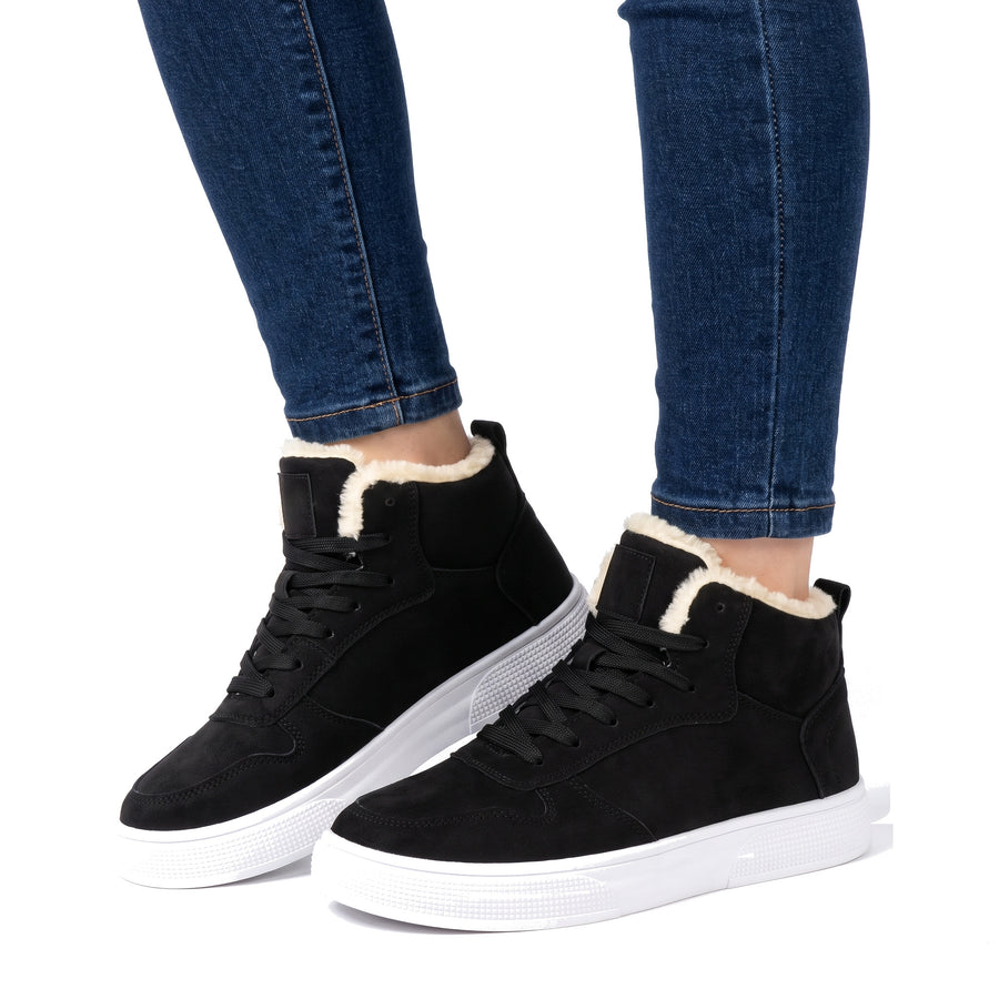 Women's warm-lined black high-top sneakers worn with dark jeans
