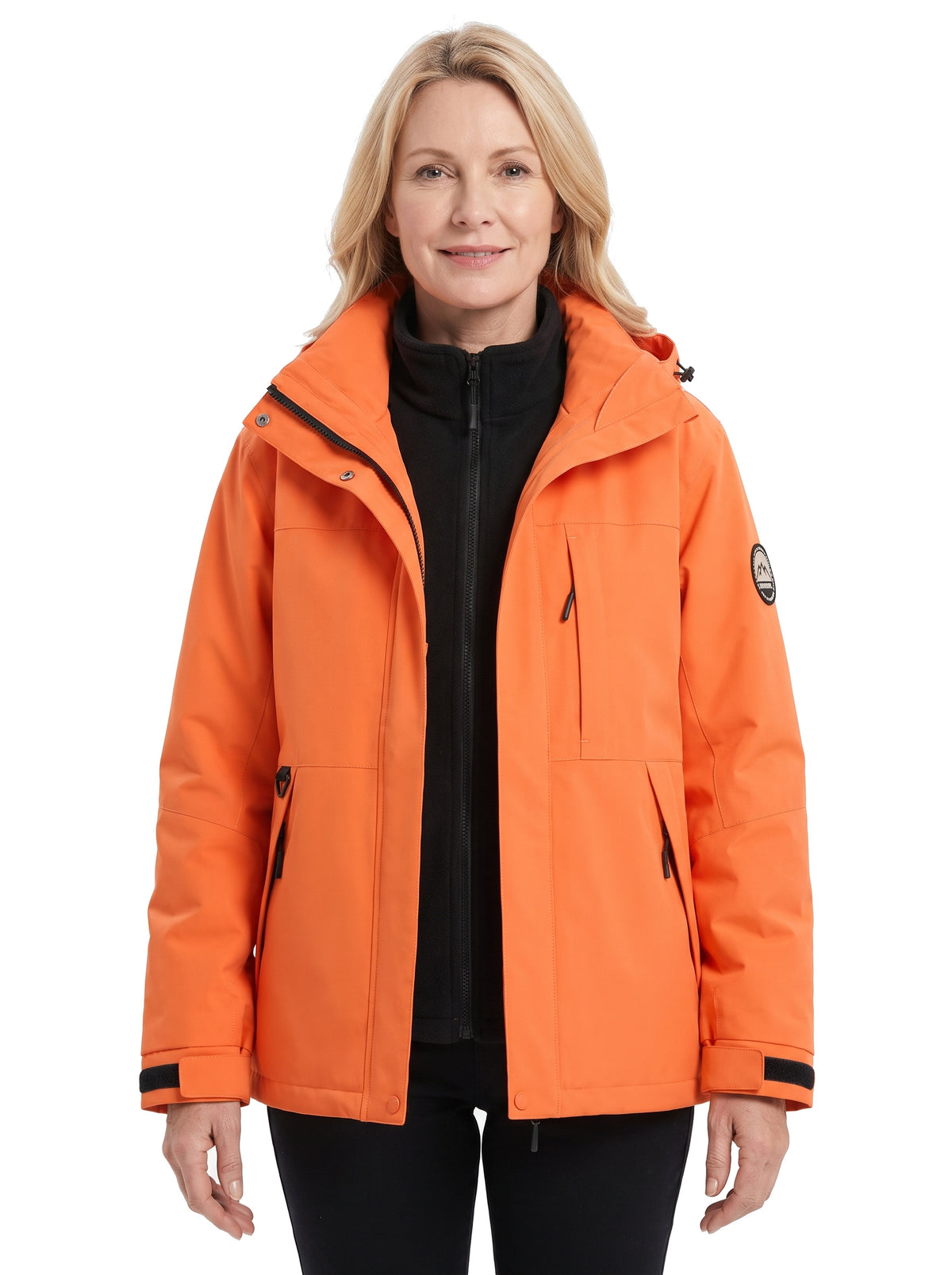Woman wearing the orange water-repellent hooded parka with removable fleece liner